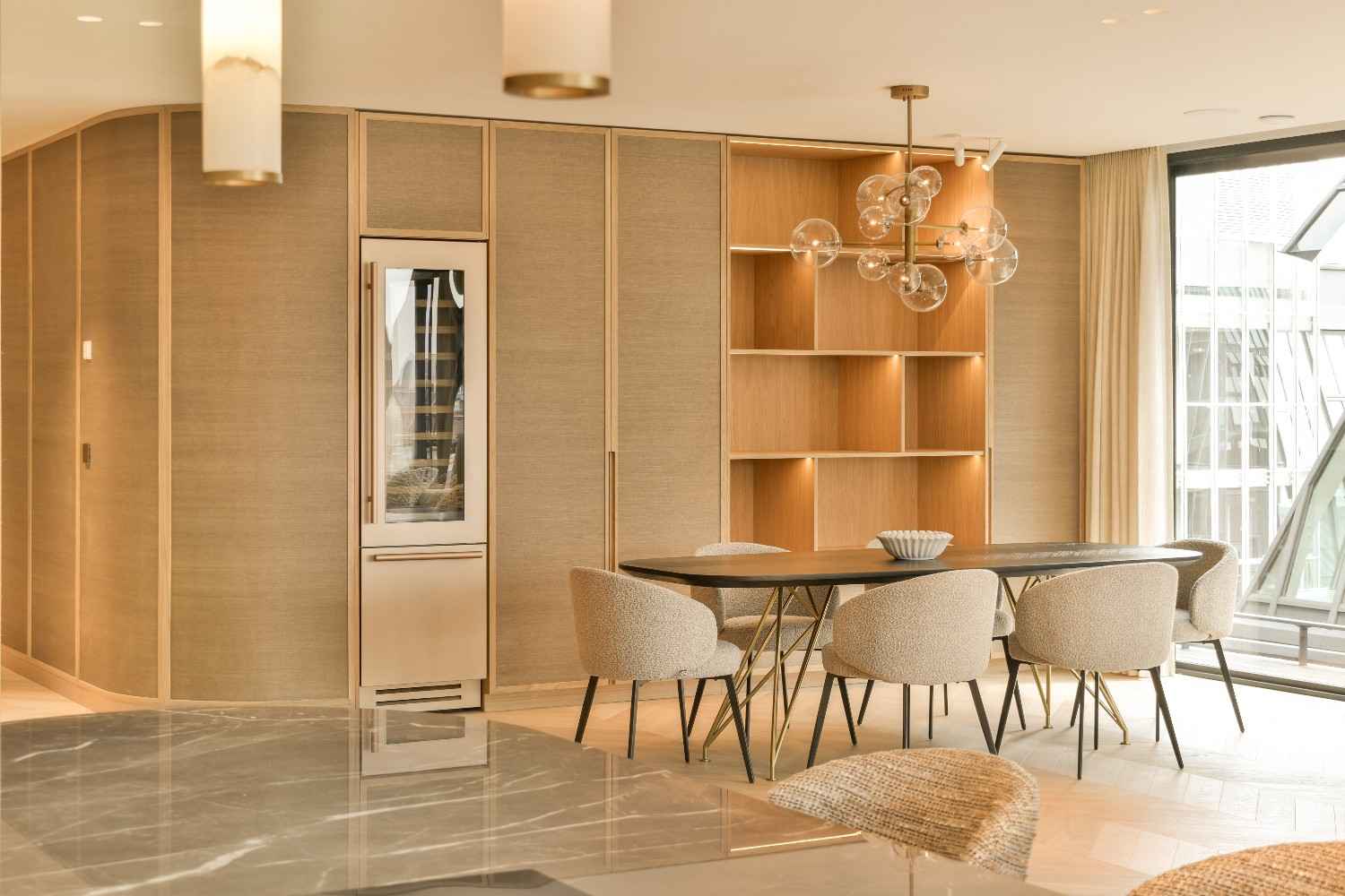 Dining area with timber wall shelving and a glass pendant light